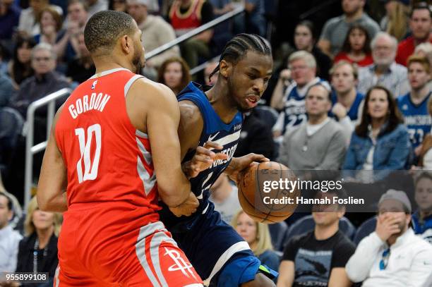 Andrew Wiggins of the Minnesota Timberwolves drives to the basket against Eric Gordon of the Houston Rockets in Game Three of Round One of the 2018...