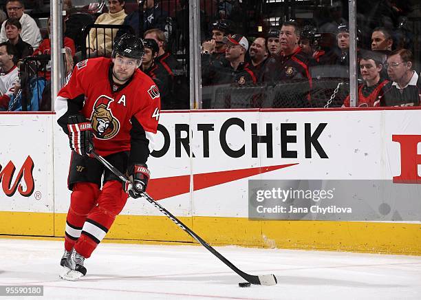 Chris Phillips of the Ottawa Senators skates with the puck against the New York Islanders at Scotiabank Place on December 31, 2009 in Ottawa,...