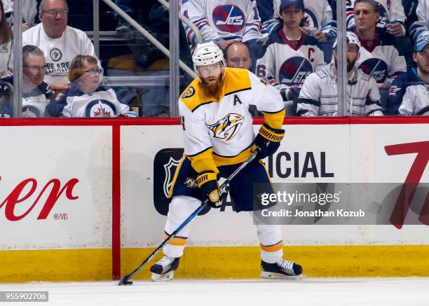 Ryan Ellis of the Nashville Predators plays the puck along the boards during first period action against the Winnipeg Jets in Game Four of the...