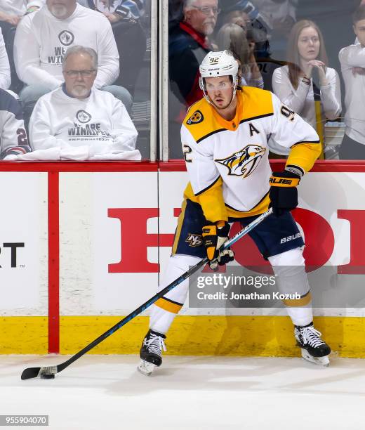 Ryan Johansen of the Nashville Predators plays the puck along the boards during second period action against the Winnipeg Jets in Game Four of the...