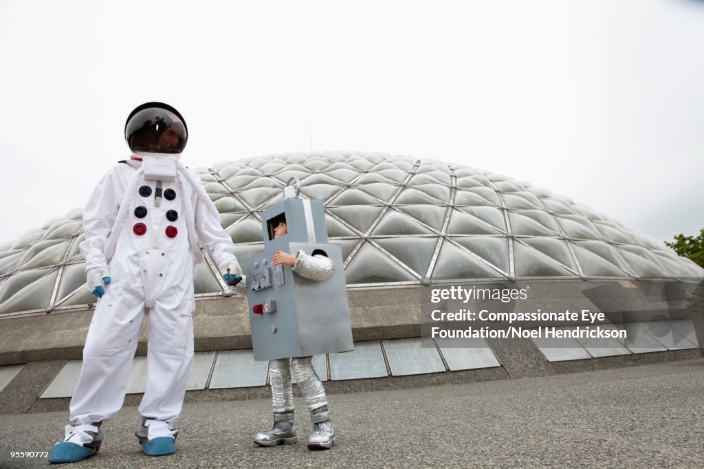 Man and boy in costumes by biosphere