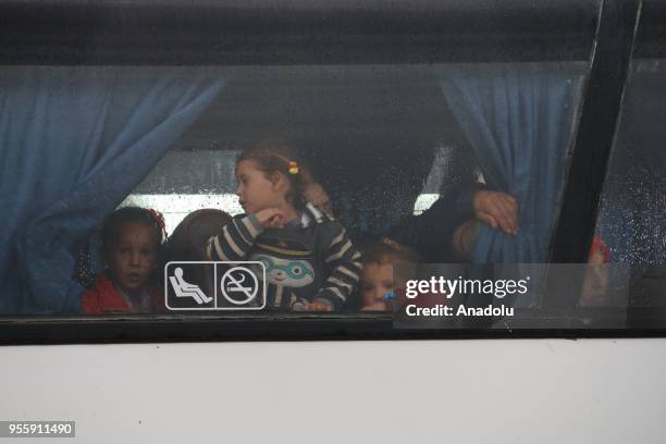 Syrian people wait to be evacuated in al-Rastan town of Homs to al-Bab district of Syria on May 8, 2018.