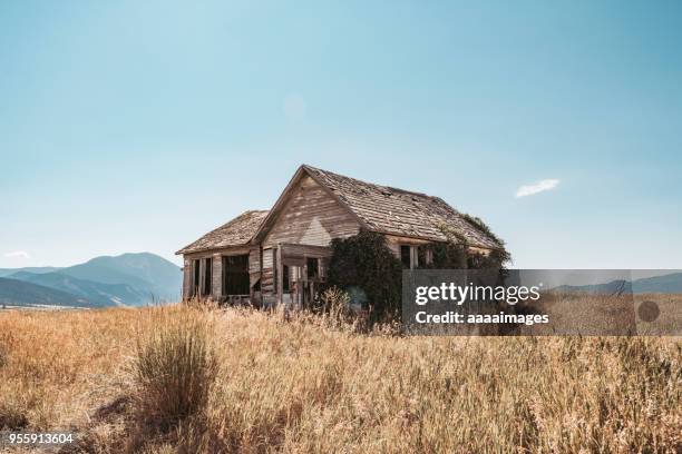 wooden barn on grass against sky - 悪い状態 ストックフォトと画像