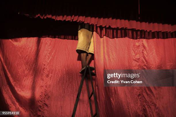Stagehand adjusts a curtain on a temporary Chinese Opera stage in the Saphan Leuang area of Bangkok. Chinese Opera, also known as Ngiew in Thailand,...