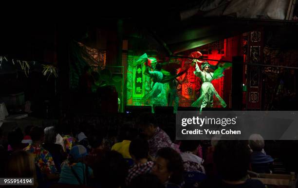 Performers dance before an appreciate audience at a Chinese Opera stage in Chinatown area of Bangkok. Chinese Opera, also known as Ngiew in Thailand,...