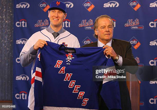 Jason Bay is presented with a New York Ranger jersey from Hall of Famer Rod Gilbert during a press conference to announce Bay's signing to the New...
