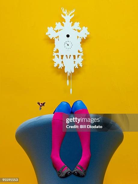 legs over chair - uhr stock-fotos und bilder