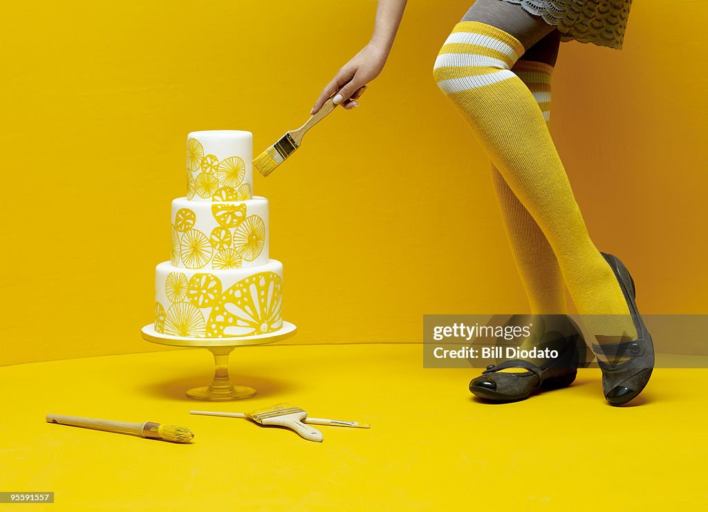 Woman painting wedding cake