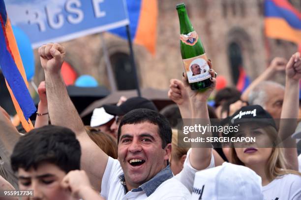 Supporters of Armenian opposition leader Nikol Pashinyan celebrate in Yerevan's Republic Square on May 8, 2018. - Armenia's parliament on May 8, 2018...