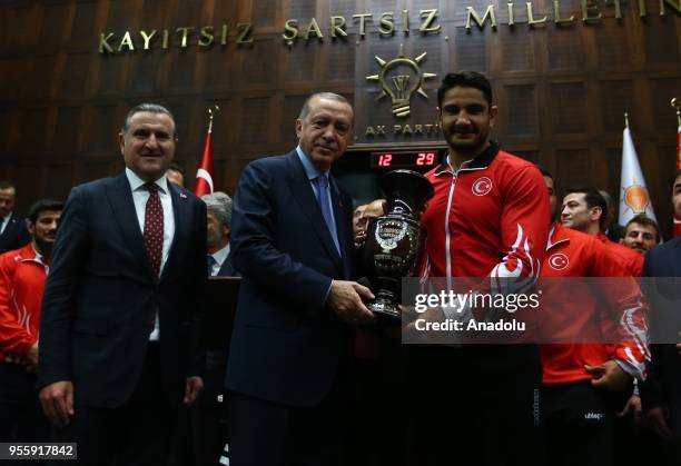President of Turkey and the leader of the Justice and Development Party Recep Tayyip Erdogan congratulates gold medalist Riza Kayaalp in the Mens...