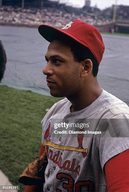 Firstbaseman Orlando Cepeda of the St. Louis Cardinals waits for the tarp to be rermoved from the field prior to a game circa June 1968 against the...