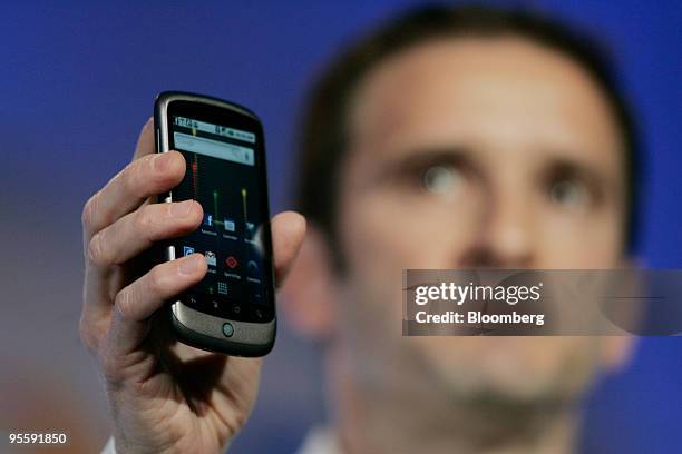Mario Queiroz, vice president of product management for Google Inc., holds up the Google Nexus One touch-screen mobile phone his company will produce...