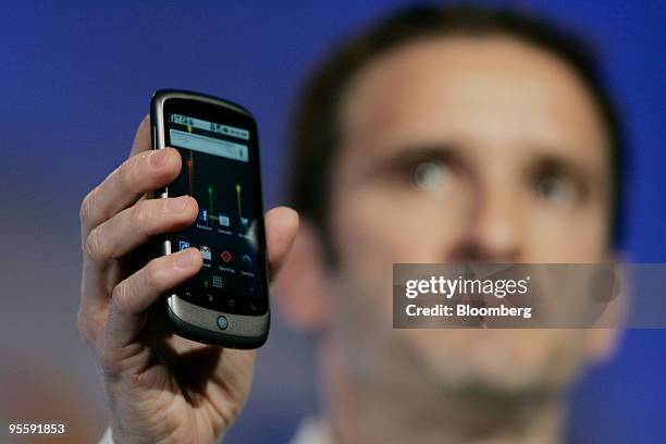Mario Queiroz, vice president of product management for Google Inc., holds up the Google Nexus One touch-screen mobile phone his company will produce...