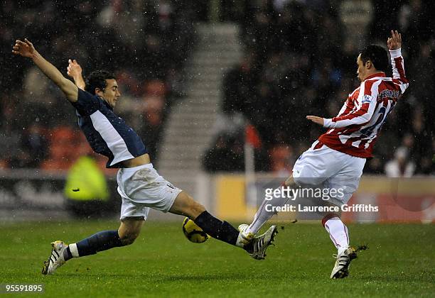 Stephen Kelly of Fulham battles with Matthew Etherington of Stoke City during the Barclays Premier League match between Stoke City and Fulham at The...