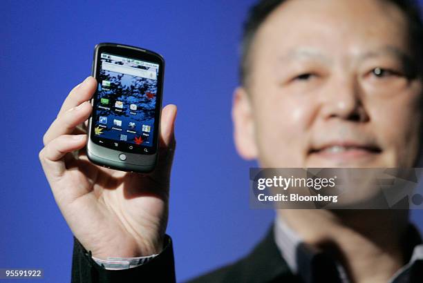 Peter Chou, chief executive officer of HTC Corp., holds the Google Nexus One touch-screen mobile phone during a news conference at Google...