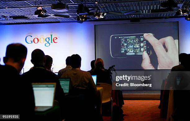 Members of the media watch as a screen shot of Erick Tseng, senior product manager for Google Inc., demonstrating a weather application on the Google...