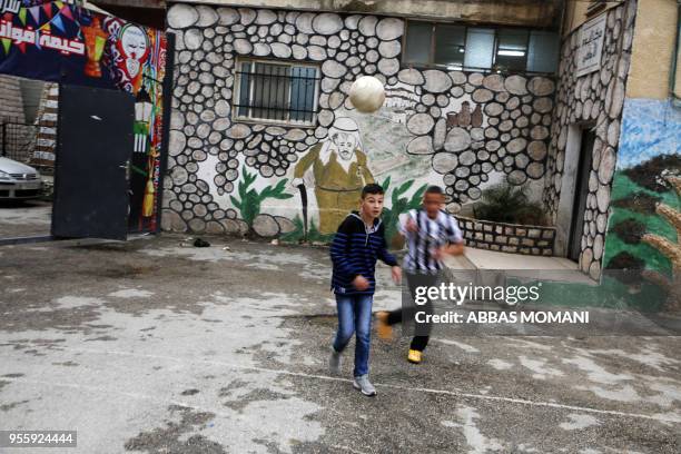 Palestinian children play in the Amari refugee camp near the West Bank city of Ramallah on May 8, 2018.