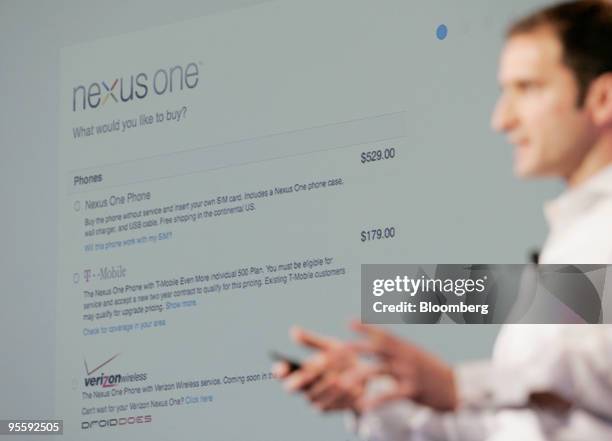 Mario Queiroz, vice president of product management for Google Inc., holds up the Google Nexus One touch-screen mobile phone during a news conference...