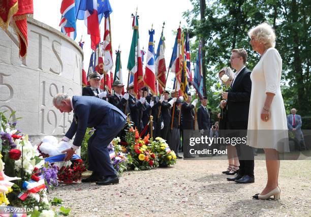 Prince Charles, Prince of Wales lays a wreath as Camilla, Duchess of Cornwall looks on as they attend VE Day Commemorations at Parc Tete d'Or on May...