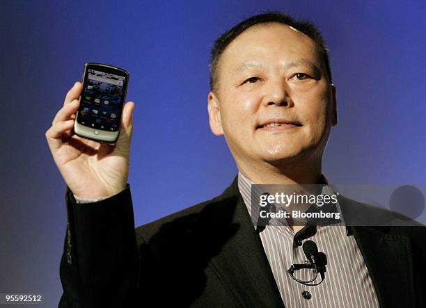 Peter Chou, chief executive officer of HTC Corp., holds the Google Nexus One touch-screen mobile phone during a news conference at Google...