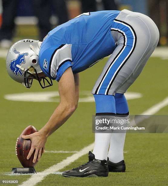 Jason Hanson of the Detroit Lions places the football on the tee before the kickoff against the Chicago Bears at Ford Field on January 3, 2010 in...