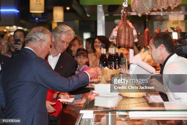 Prince Charles, Prince of Wales trys some of the local produce as he visits Les Halles de Lyon-Paul Bocuse food market on May 8, 2018 in Lyon, France.