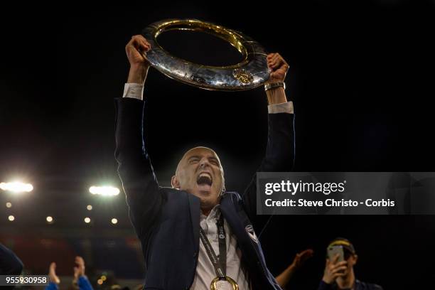 Coach Kevin Muscat of Melbourne Victory celebrates by holding up the A-League trophy in front of fans after winning the 2018 A-League Grand Final...