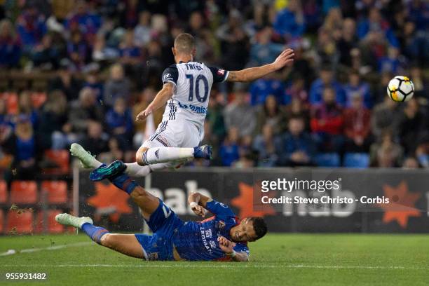 James Troisi of Melbourne Victory jumps in this challenge from Jets Daniel Georgievski the 2018 A-League Grand Final match between the Newcastle Jets...