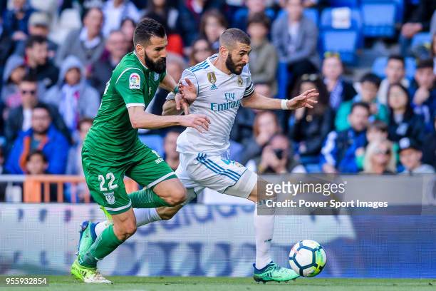 Dimitrios Siovas of CD Leganes fights for the ball with Karim Benzema of Real Madrid during the La Liga 2017-18 match between Real Madrid and CD...