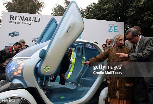 Delhi chief minister Shiela Dikshit checks the Twizy Z.E. Concept City two-seater car by French Auto major Renault during its launch at her residence...