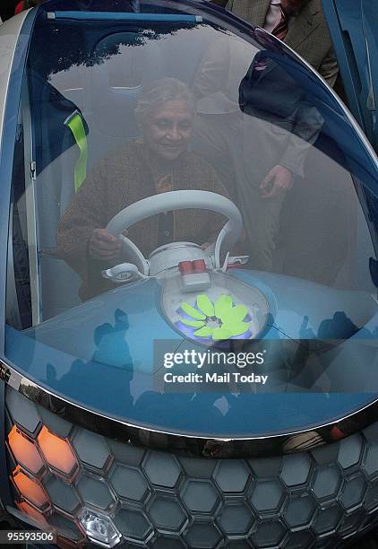 Delhi chief minister Shiela Dikshit checks the Twizy Z.E. Concept City two-seater car by French Auto major Renault during its launch at her residence...