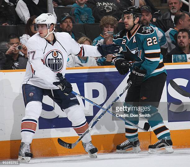 Denis Grebeshkov of the Edmonton Oilers holds off Dan Boyle of the San Jose Sharks during an NHL game on January 2, 2010 at HP Pavilion at San Jose...