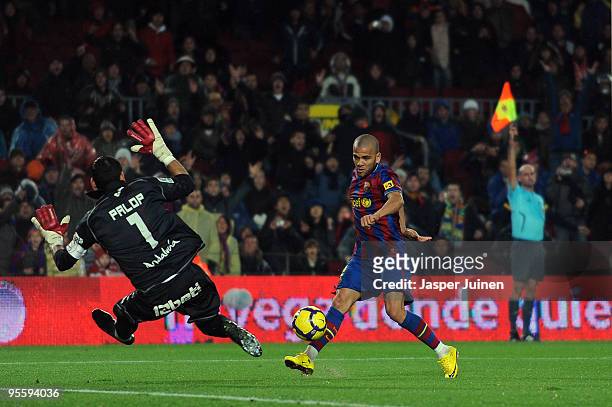 Daniel Alves of FC Barcelona scores past goalkeeper Andres Palop of Sevilla as the assistant referee flags for offside disalowing the goal during the...