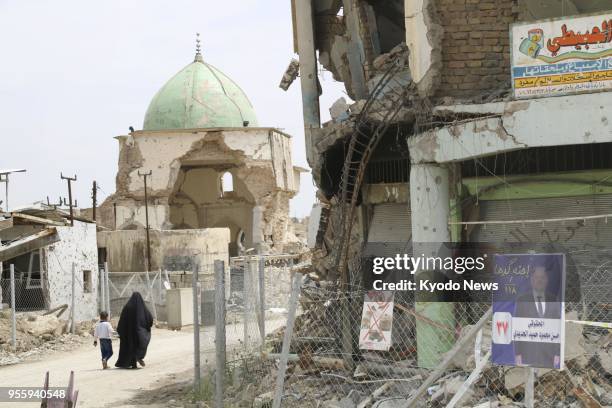 People walk towards the ruined Great Mosque of al-Nuri in Mosul's Old City in Iraq on May 6, 2018. ==Kyodo