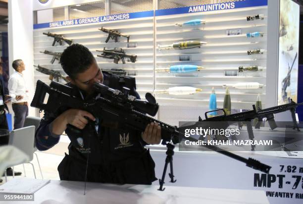 Visitor inspects a Turkish-made MPT-76 assault rifle on display at the Special Operations Forces Exhibition and Conference in the Jordanian capital...