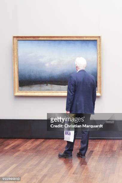 Visitors looks at the artwork 'Moench Am Meer' by Caspar David Friedrich during the exhibition preview for 'Wanderlust. Von Caspar David Friedrich...