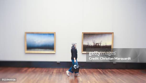 Visitors passing by the artwork 'Abtei im Eichwald' by Caspar David Friedrich during the exhibition preview for 'Wanderlust. Von Caspar David...