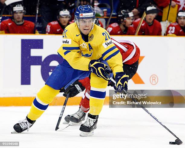 Magnus Paajarvi-Svensson of Team Sweden skates with the puck while being defended by Jeffrey Fuglister of Team Switzerland during the 2010 IIHF World...