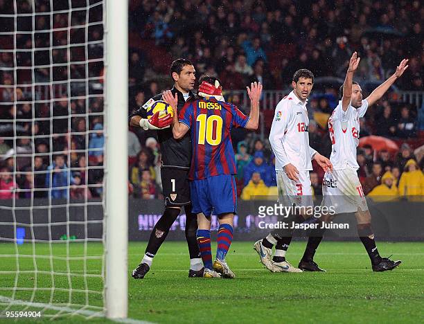 Goalkeeper Andres Palop of Sevilla holds Lionel Messi of FC Barcelona as Ivica Dragutinovic and Fernando Navarro of Sevilla look on during the 1/8...