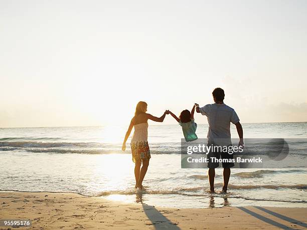 mother and father swinging daughter by arms - mexican mothers day 個照片及圖片檔