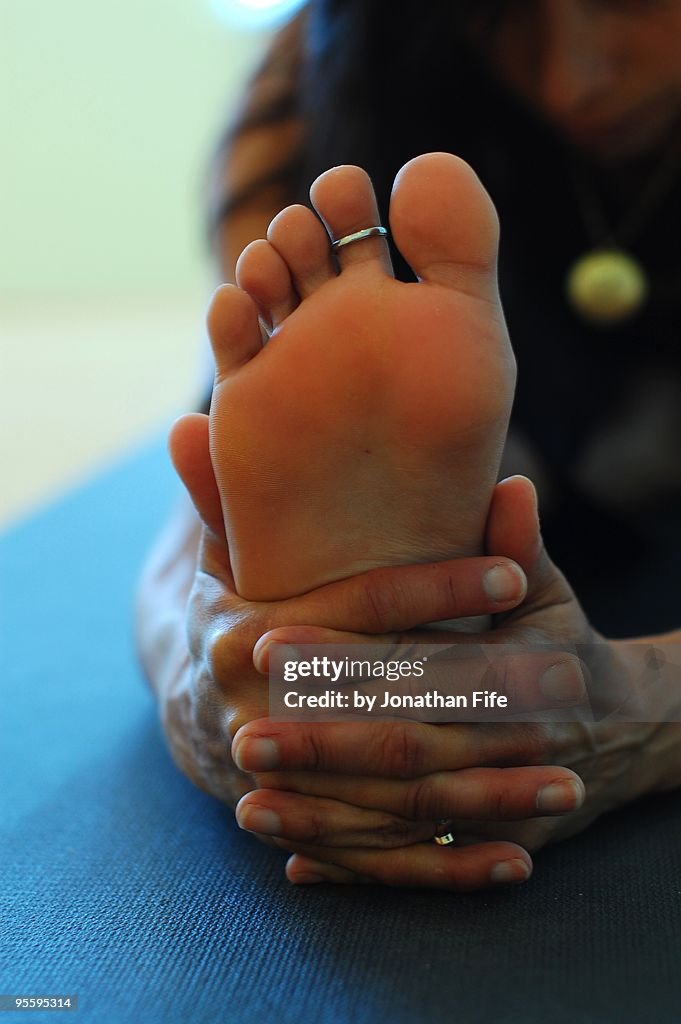 Woman doing the yoga pose Janu sirsasana