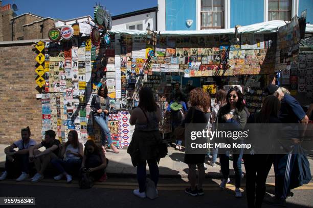 Popular stall selling metal street signs, old fashioned brands and music prints on Portobello Road Market in Notting Hill, West London, England,...