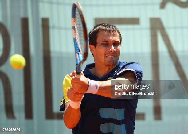 Evgeny Donskoy of Russia plays a backhand against Stefanos Tsitsipas of Greece in their first round match during day four of the Mutua Madrid Open...