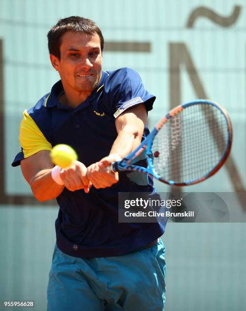 Evgeny Donskoy of Russia plays a backhand against Stefanos Tsitsipas of Greece in their first round match during day four of the Mutua Madrid Open...