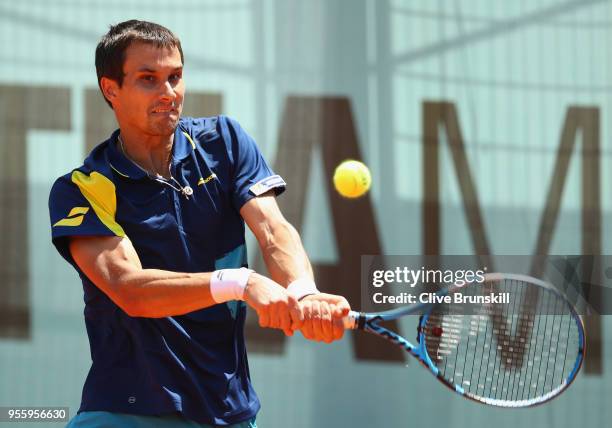 Evgeny Donskoy of Russia plays a backhand against Stefanos Tsitsipas of Greece in their first round match during day four of the Mutua Madrid Open...