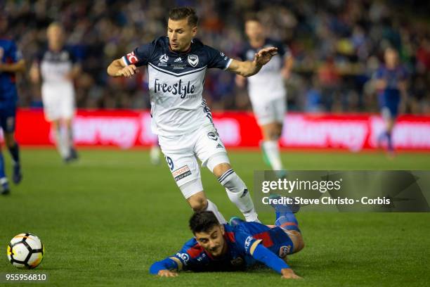 Kosta Barbarouses of Melbourne Victory tackles Jets John Koutroumbis during the 2018 A-League Grand Final match between the Newcastle Jets and the...