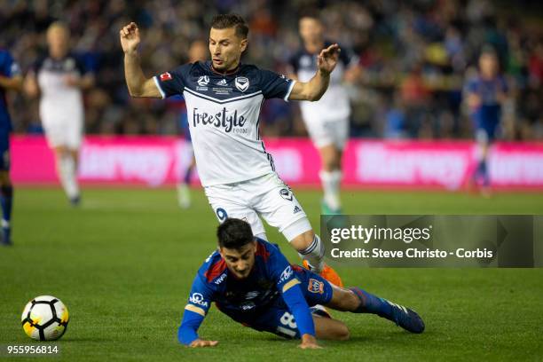 Kosta Barbarouses of Melbourne Victory tackles Jets John Koutroumbis during the 2018 A-League Grand Final match between the Newcastle Jets and the...