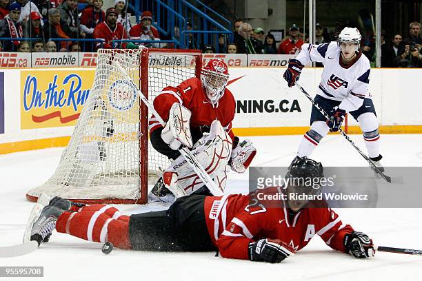 Alex Pietrangelo of Team Canada blocks a pass to Matt Donovan of Team USA in front of Jake Allen during the 2010 IIHF World Junior Championship...