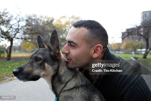 man whispering to dog in park - eén dier stockfoto's en -beelden