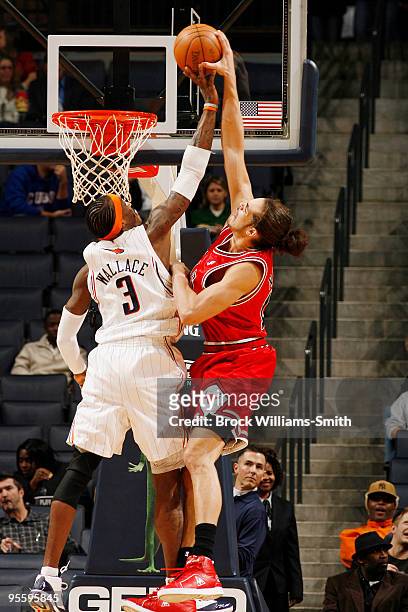 Gerald Wallace of the Charlotte Bobcats blocks a shot by Joakim Noah of the Chicago Bulls on January 5, 2010 at the Time Warner Cable Arena in...